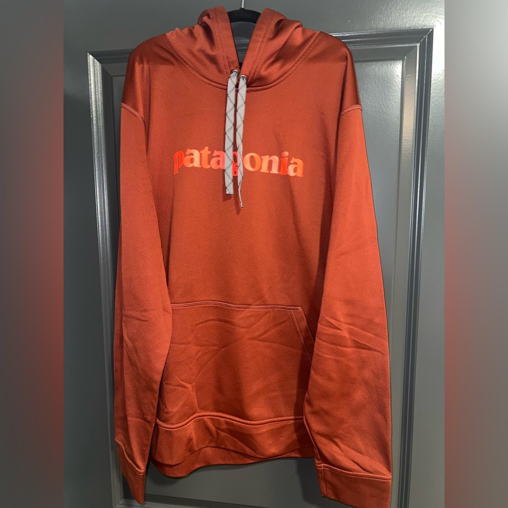 Patagonia burgundy Hoodie with orange lettering